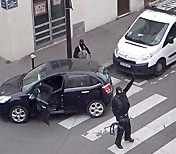 gunmen-gesture-as-they-return-to-their-car-after-the-attack-outside-the-offices-of-french-satirical-weekly-newspaper-charlie-hebdo